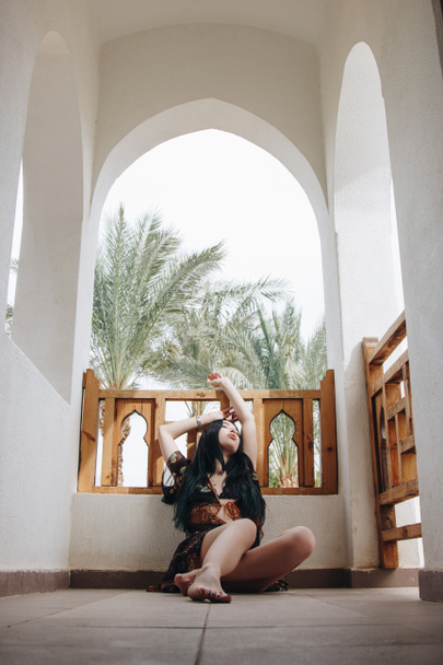 seductive young barefoot woman sitting on floor at resort in Egypt - Fotografie, Obrázek