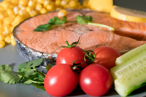 fresh tomato on the grilled fish salmon fillet  dish, food and vegetable concept - Photo, image