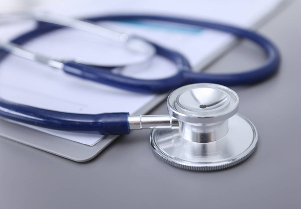 Medical equipment: blue stethoscope and tablet on white background. Medical equipment - Valokuva, kuva