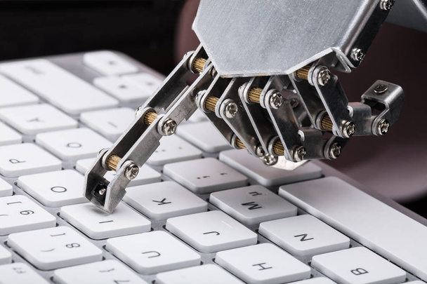 Close-up Of A Robotic Hand Typing On Keyboard - Φωτογραφία, εικόνα