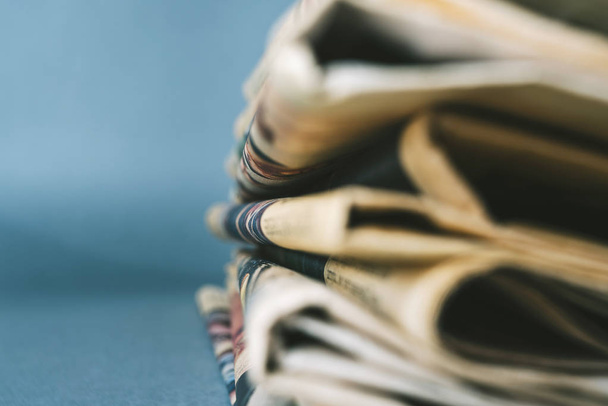Newspapers on blue background, macro view - Foto, Imagen