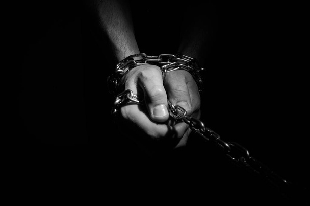 Hands are chained in chains isolated on black background - Фото, зображення