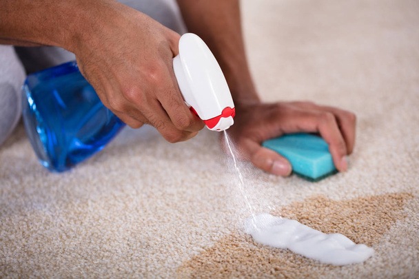 Janitor Cleaning Spilled Coffee On Carpet With Spray Bottle - Foto, Imagen