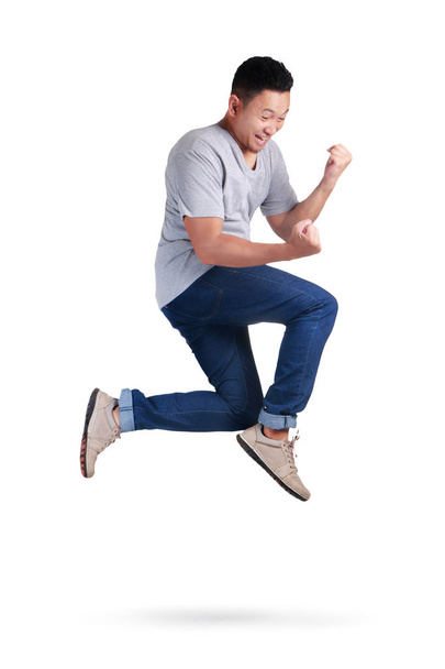 Levitation. Young Asian man jumping dancing walking - Φωτογραφία, εικόνα