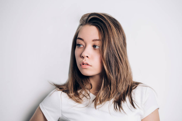 Portrait of beautiful girl posing on a white background, - Fotografie, Obrázek