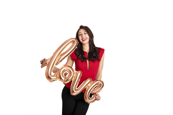 Beautiful millennial female fashion model in stylish clothes posing for 14 february valentines day photo shoot. 90's kid, young woman smiling, laughing, air kiss, holding letter balloons. Copy space. - Foto, Imagem