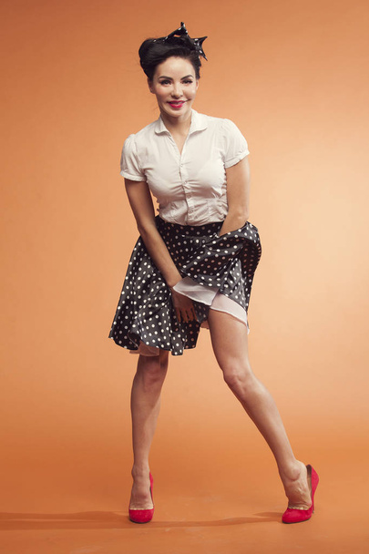girl holds skirt in polka dot - Zdjęcie, obraz