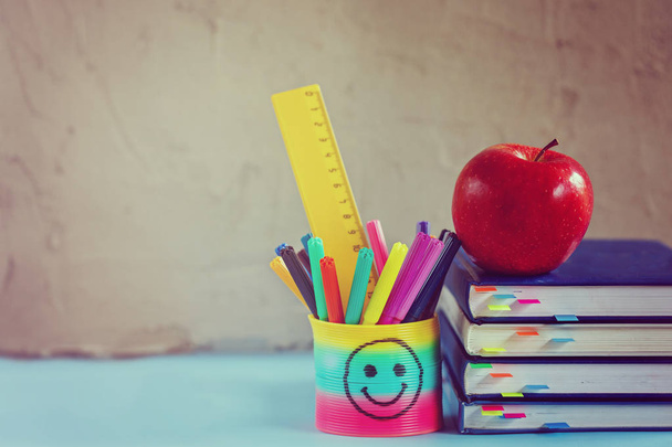 Group of school supplies and books and red apple over on backgro - Foto, Imagen