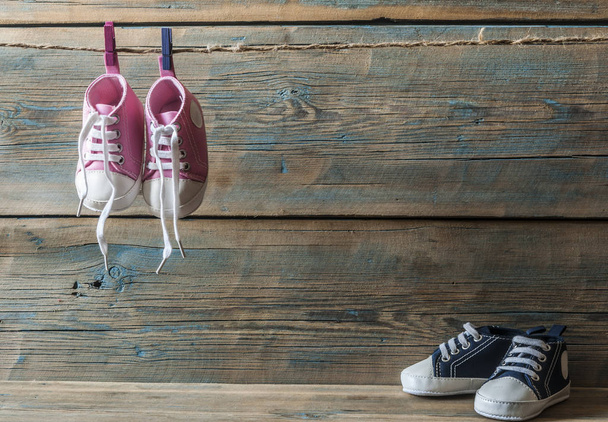 Baby shoes hanging on the clothesline. - Valokuva, kuva