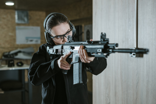 girl aiming rifle in shooting range - Photo, Image
