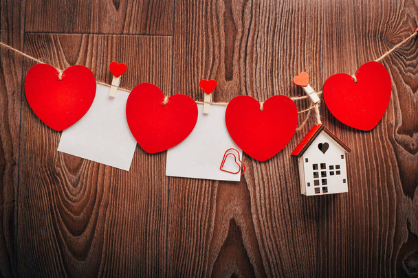 Love Valentine's hearts and card natural cord and red clips hanging on rustic driftwood texture background, copy space - Φωτογραφία, εικόνα