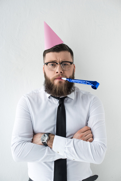 portrait of businessman with party cone on head isolated on grey - Fotoğraf, Görsel