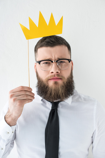 retrato de hombre de negocios barbudo en ropa formal con corona de papel aislada en gris
 - Foto, Imagen