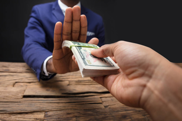Close-up Of Businessman's Hand Refusing To Take Bribe From Partner - Valokuva, kuva