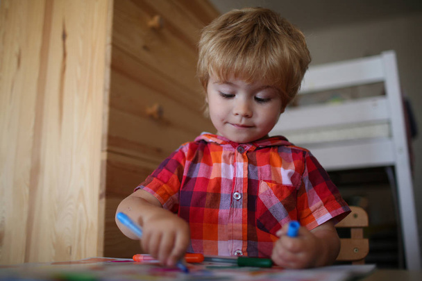 Education and hobby. Painter child play with coloring book. Childhood and happiness, learning. Kid or blonde happy boy paint with felt pen. Small boy child drawing with colorful marker pen. - Фото, зображення
