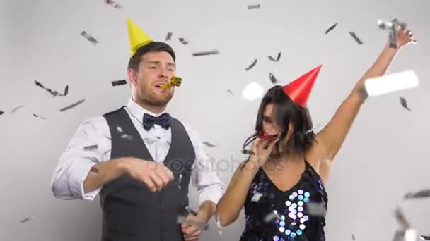 happy couple with party blowers having fun - Кадры, видео