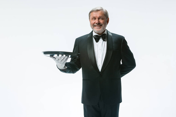 Senior waiter holding tray - 写真・画像