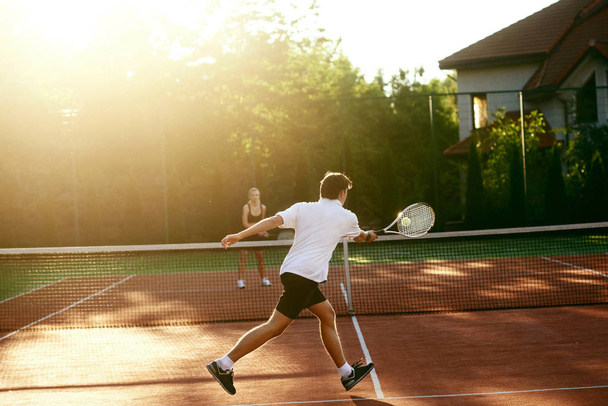 Young People Playing Tennis Outdoors - Фото, зображення