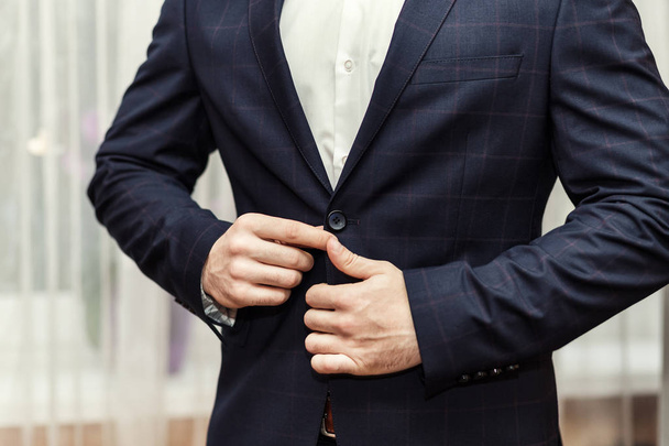 Businessman wears a jacket,male hands closeup,groom getting ready in the morning before wedding ceremony - Photo, Image