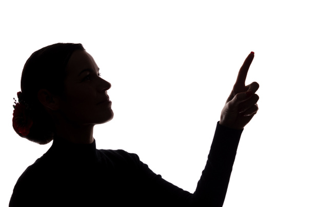 Mujer joven de traje muestra su dedo índice, la mano hacia adelante silueta
 - Foto, imagen