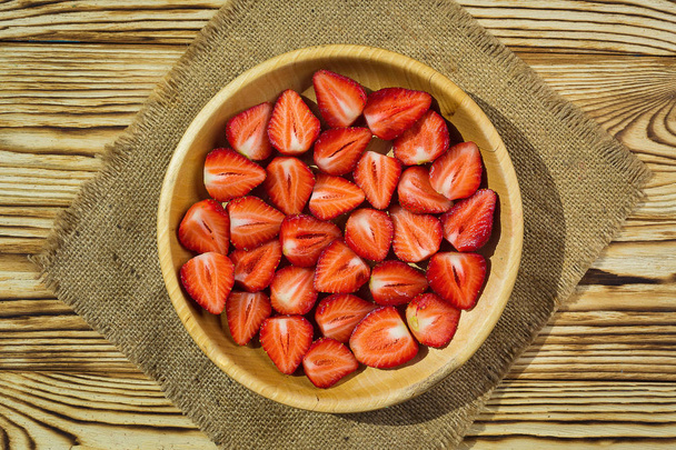 strawberries in basket on wooden table in natural background, delicious first class organic fruit as a concept of summer vitamins - Φωτογραφία, εικόνα