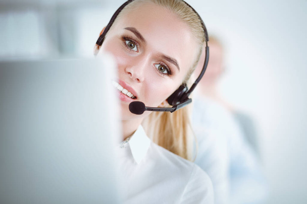 Attractive positive young businesspeople and colleagues in a call center office. Businesspeople - Fotoğraf, Görsel