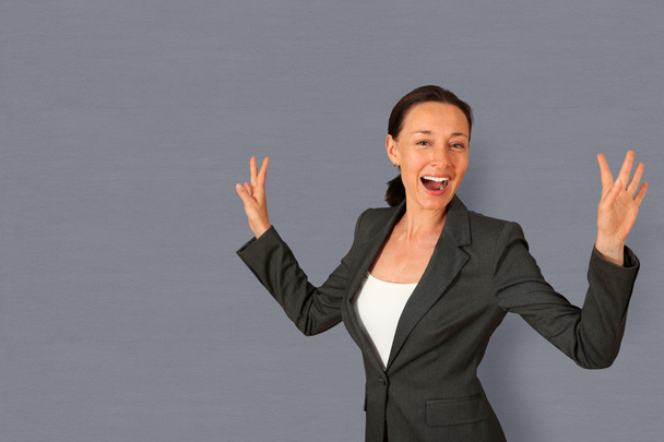Successful businesswoman showing satisfaction - Valokuva, kuva