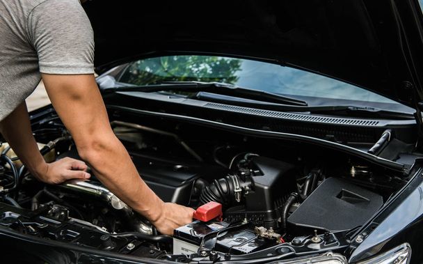 Hand of mechanic is repairing car engine - Фото, зображення