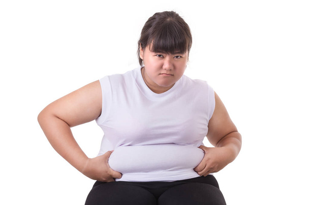 Fat Asian woman wear white t-shirt worried about her body size   - Foto, afbeelding