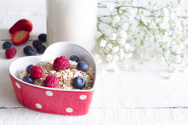 Porridge oatmeal with fruits in heart valentines food love concept  - Фото, изображение