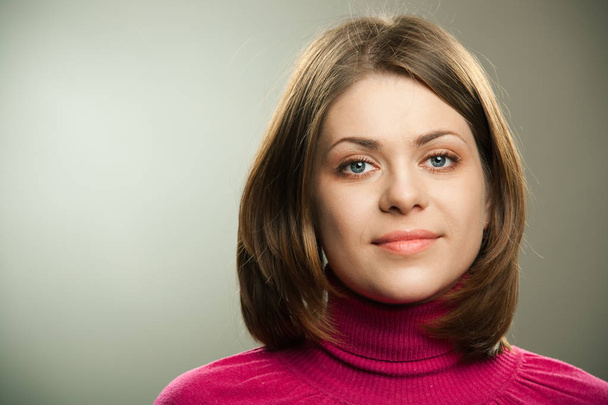Portrait of young beautiful woman in pink sweater looking at camera  - Fotografie, Obrázek