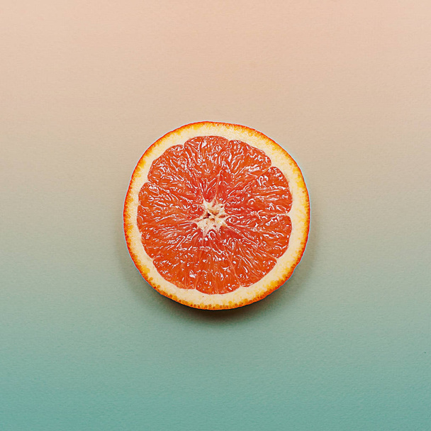 Minimal style, creative layout orange and grapefruit. Flat lay. Food concept. Half an orange on turquoise pink background. - Foto, imagen