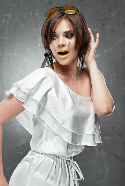 beautiful young model with yellow lipstick on lips in white dress with naked shoulder - Fotografie, Obrázek