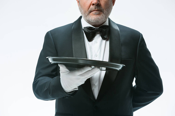 Senior waiter holding tray - 写真・画像
