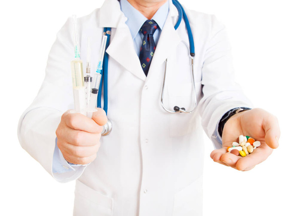 doctor holding syringes and pills in hands  - Foto, Imagen