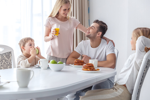 young family taking breakfast together at home - Foto, immagini
