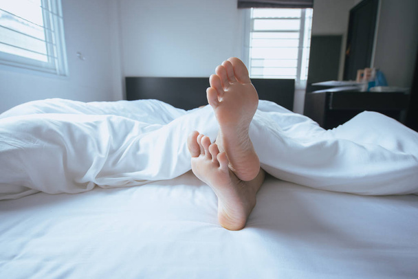 Close up of  barefoot,Feet and stretch lazily on the bed after waking up - Fotografie, Obrázek