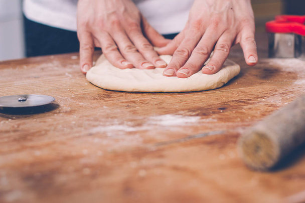 close-up of female hands making cookies from dough at home kitchen - 写真・画像