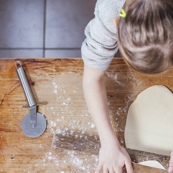 little girl making dough at home kitchen - Valokuva, kuva