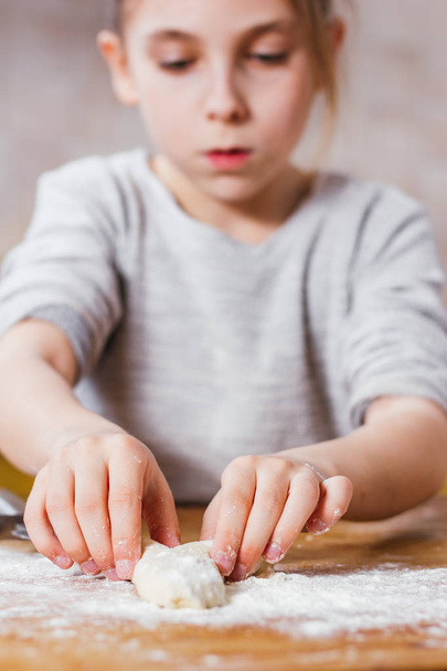 little girl making dough at home kitchen - Foto, imagen