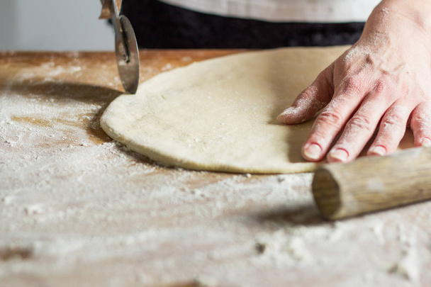 close-up of female hands making cookies from dough at home kitchen - Photo, image