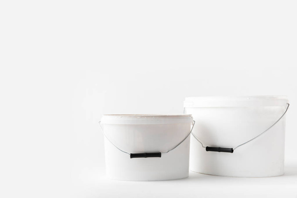 two plastic white buckets with paints isolated on white - Fotoğraf, Görsel