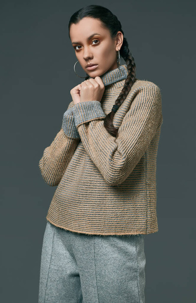 Portrait of beautiful charming hispanic girl in cozy sweater - Photo, Image