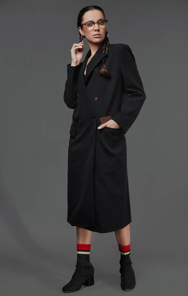 Portrait of beautiful charming hispanic girl in long black coat - Foto, Imagem