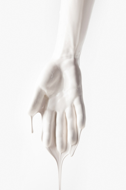 cropped image of female arm in white dripping paint isolated on white - Fotó, kép