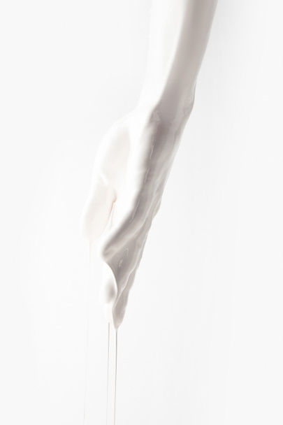 cropped image of girl in white paint dripping isolated on white - Фото, изображение