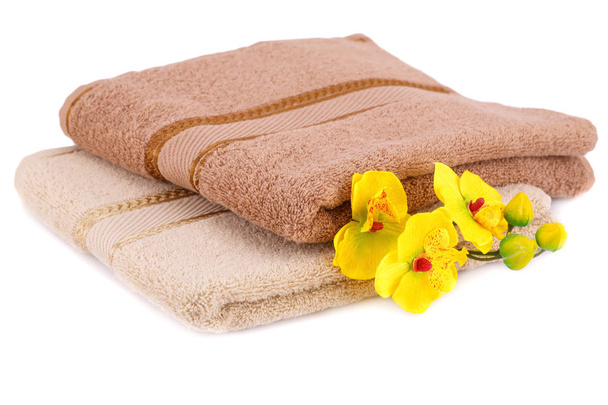Folded towels and flowers isolated on white background. - Photo, Image