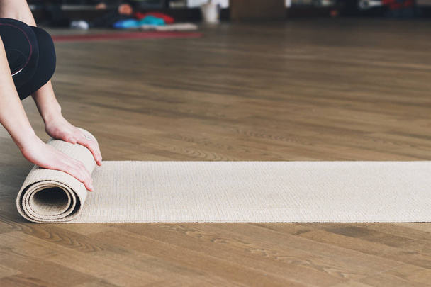 Жінка катається на килимку після занять з йоги
 - Фото, зображення