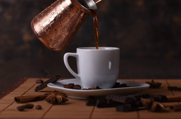 Hot fresh coffee is pouring into a cup - Foto, Imagen