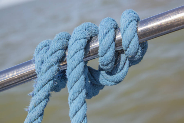 Marine rope tied around a steel bar - Photo, image